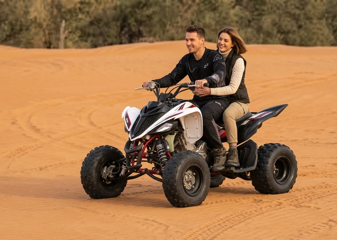 Tourist enjoying one hour quad biking adventure in Dubai red dunes desert riding powerful ATV through open sand landscape with guide.
