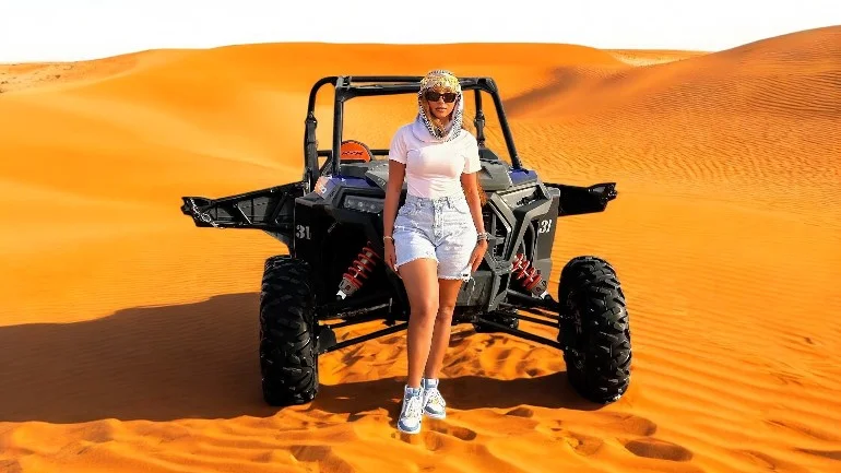 Morning dune buggy ride in Dubai desert with soft untouched sand and bright sunrise over wide red dunes near Big Red area