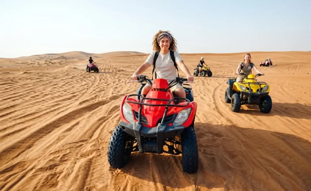 Beginner tourist learning to ride quad bike in Dubai desert with instructor guidance showing easy controls and beginner friendly ATV experience