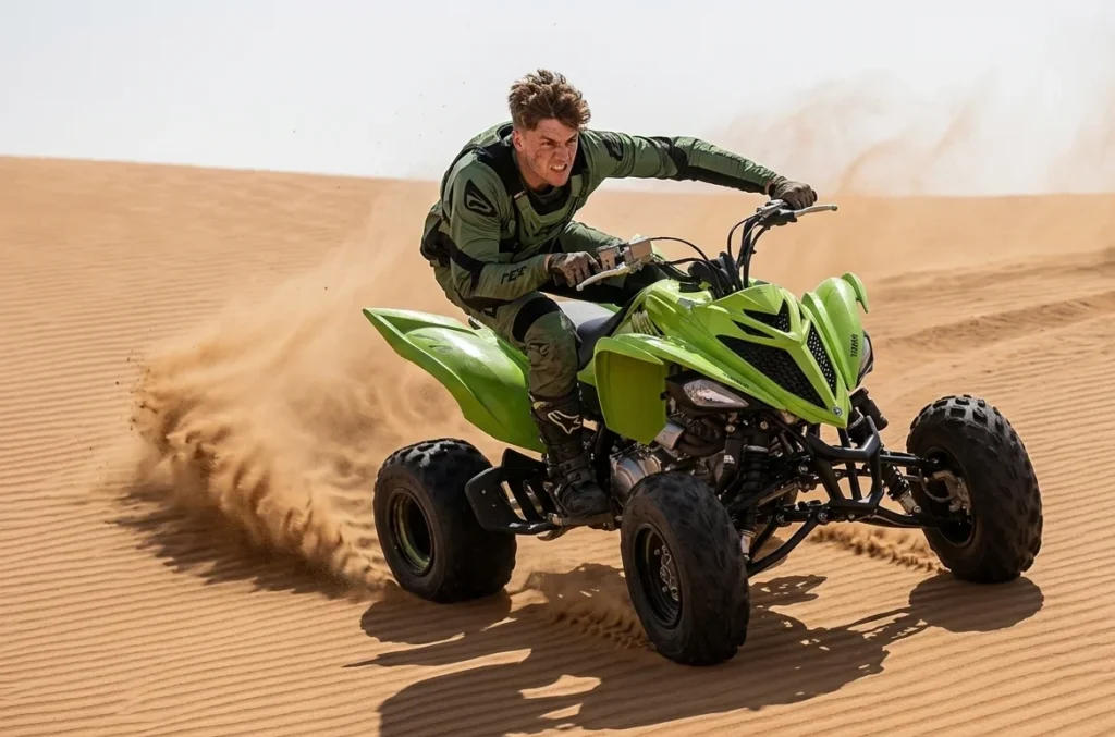 Tourist riding a quad bike across red sand dunes in Dubai desert during guided tour experience showing that quad biking in Dubai needs no license required