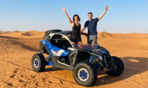 Rider wearing helmet and goggles before dune buggy ride in Dubai desert, showing essential safety gear used for beginner off road driving tours