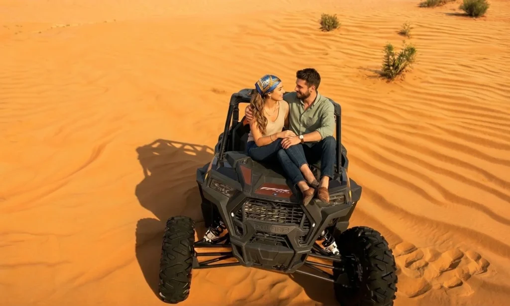 Group of dune buggies following a guide across red dunes in Dubai desert, highlighting structured and guided off road experience for beginners