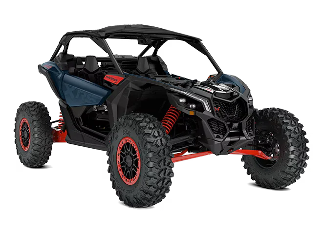 Can-Am X3 dune buggy driving across Dubai desert dunes during an off-road adventure tour
