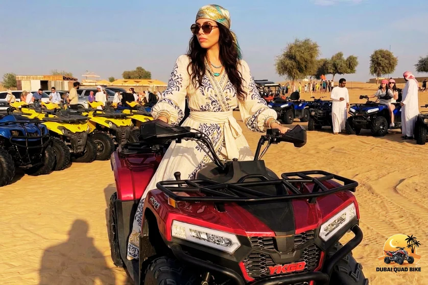 Group of riders driving quad bikes together across desert landscape in Dubai following guide with safe distance and enjoying shared outdoor adventure experience