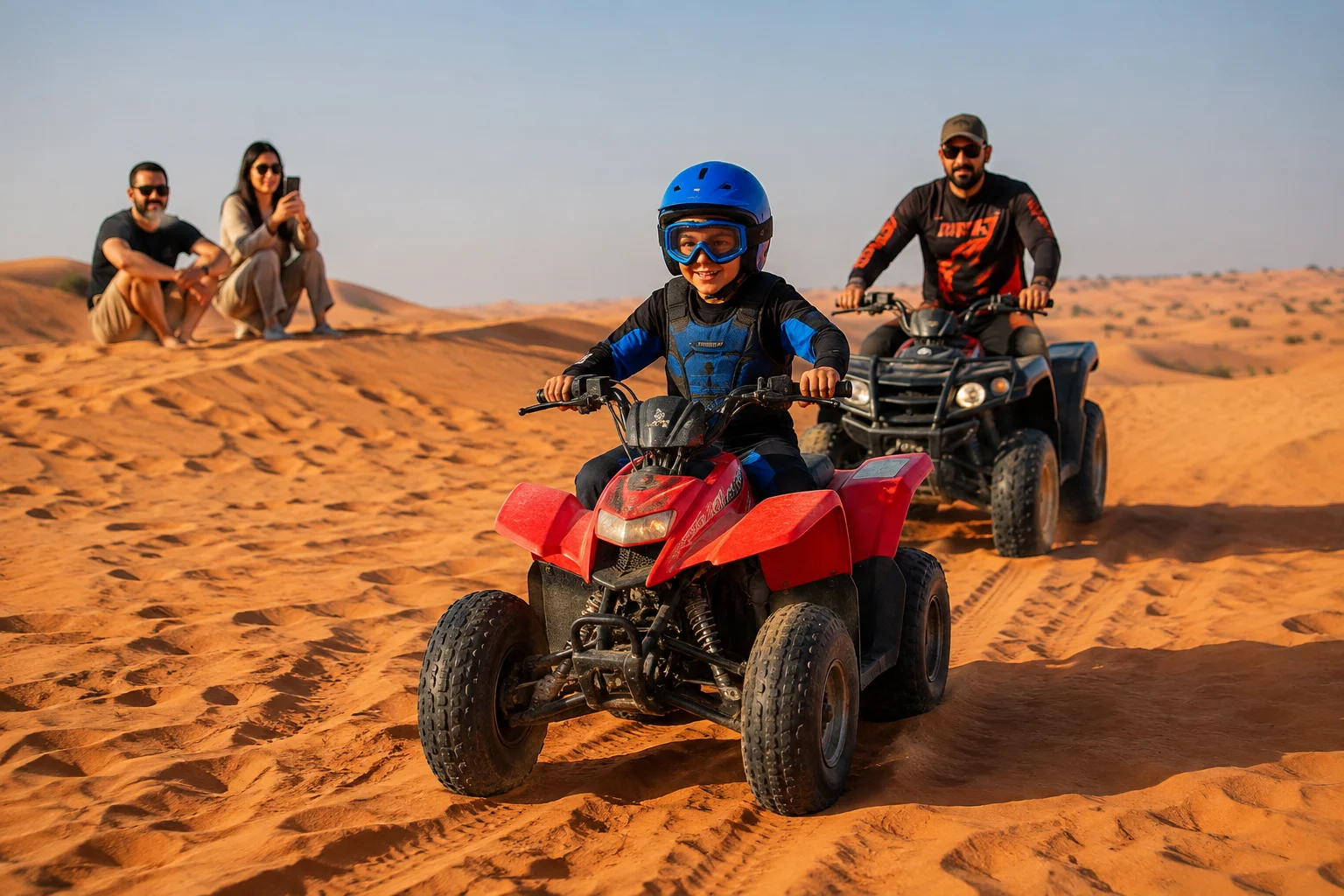 A child riding a kids quad bike across Dubai's red sand dunes during a guided summer holiday desert adventure with professional safety equipment.