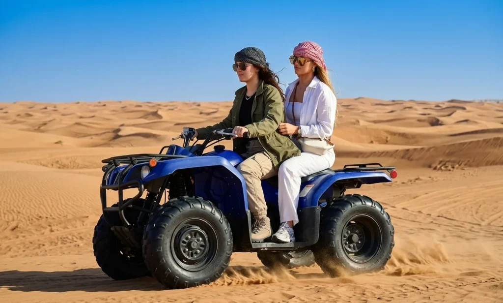 Quad biking across Dubai desert dunes during the best season for ATV riding