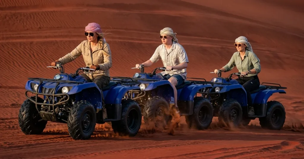 ATV quad bike riding across the sandy dunes of the Dubai desert