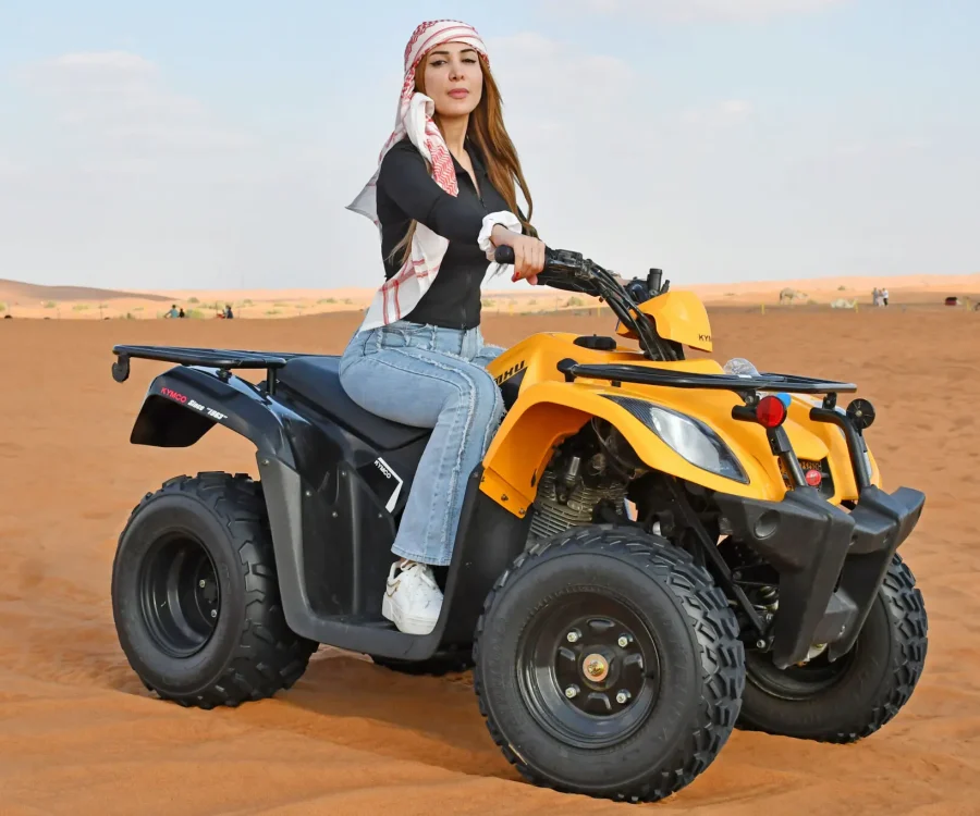 Single seat quad bike Dubai desert adventure ride.